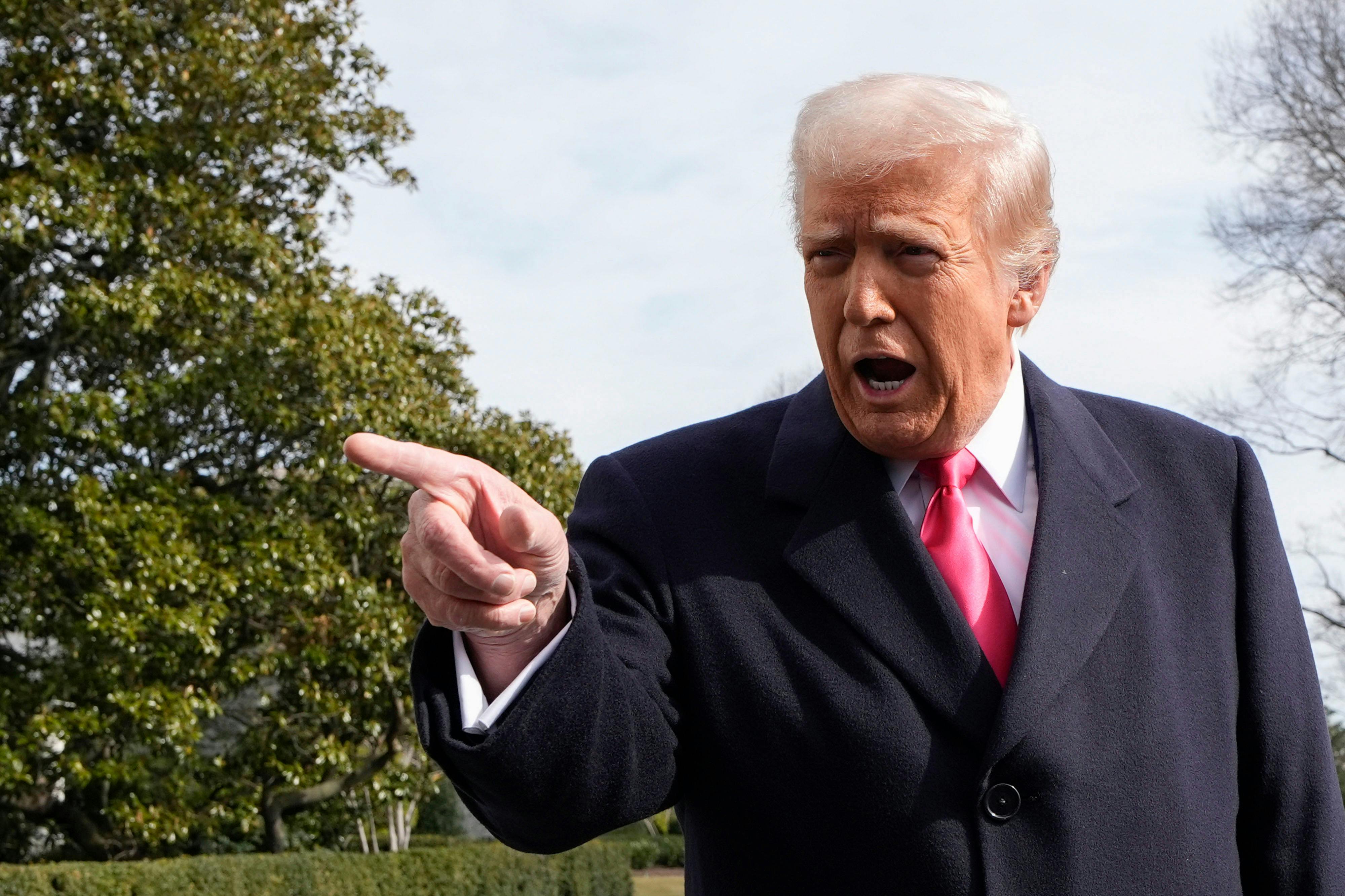 Trump points off camera vigorously while speaking.