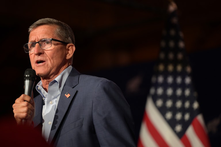 Michael Flynn holds a microphone as he speaks