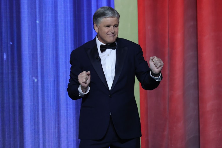 Sean Hannity dances on stage at an event