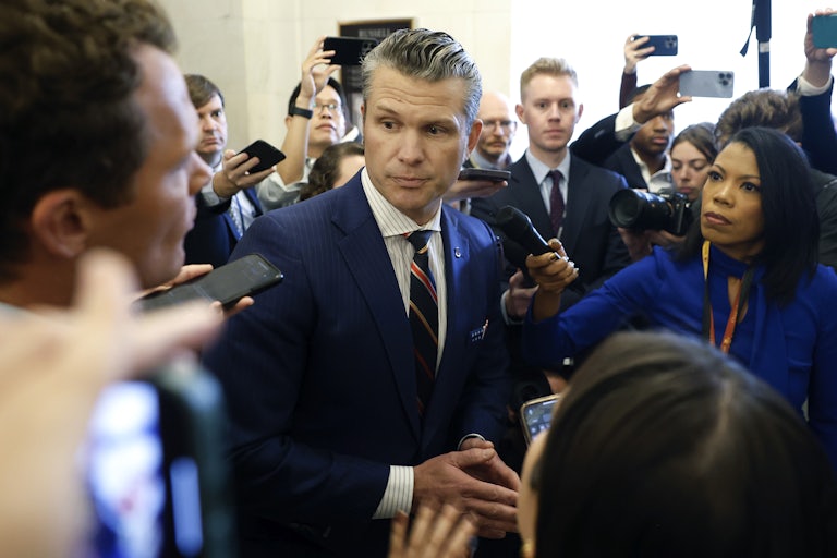 Pete Hegseth surrounded by members of the press