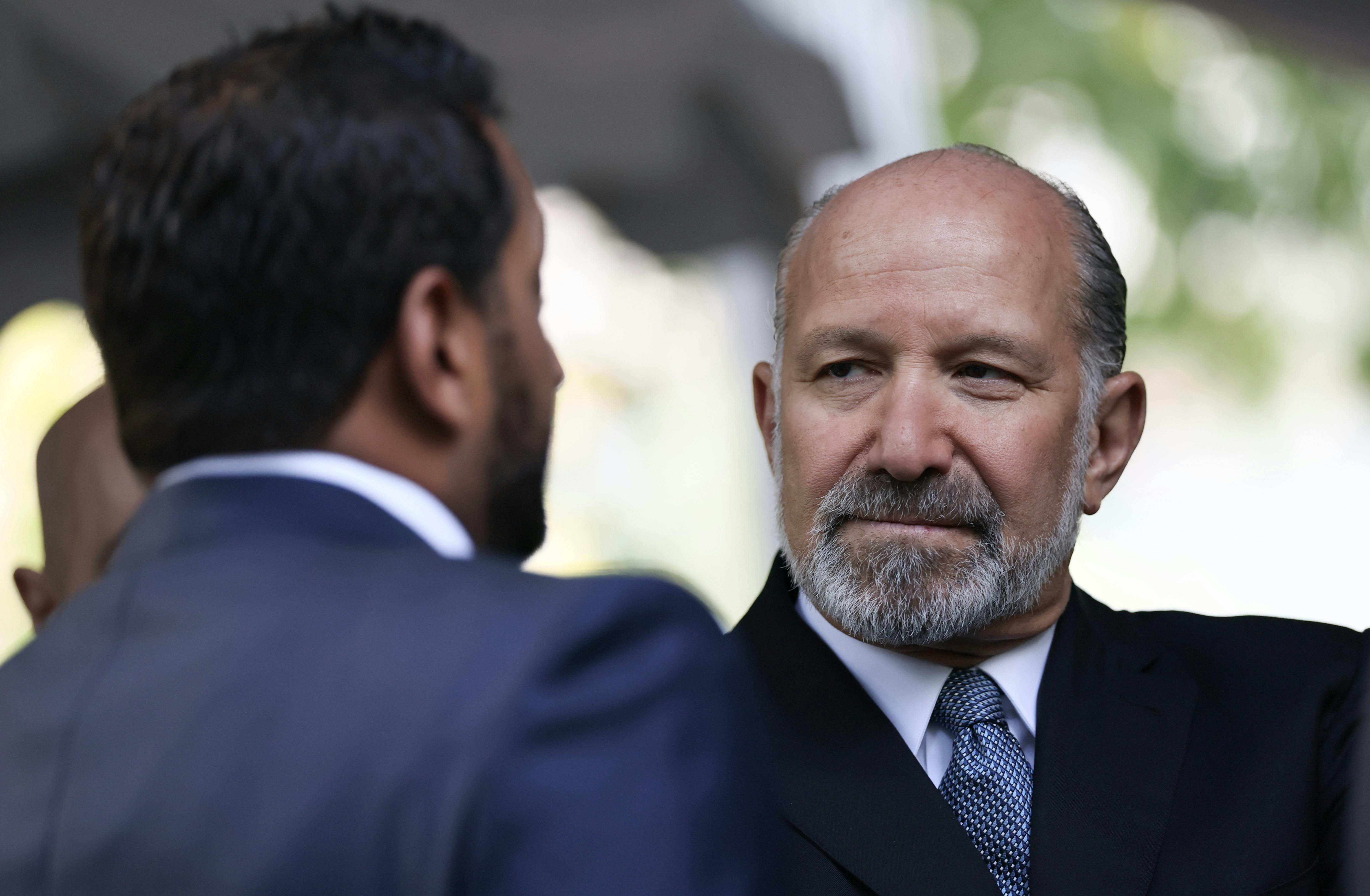 Commerce Secretary Howard Lutnick looks at Kash Patel (who only has the back of his head pictured).