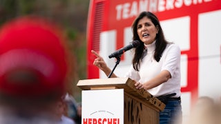 Nikkie Haley speaks at a podium that reads "Herschel for Senate." She is pointing her right finger to emphasize a point.