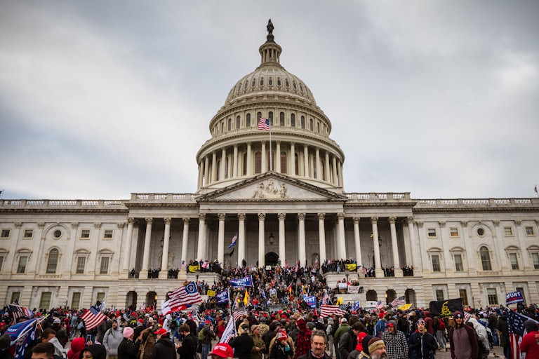 A large group of pro-Trump protesters stand on the East steps of the Capitol Building after storming its grounds on January 6, 2021 in Washington, DC.