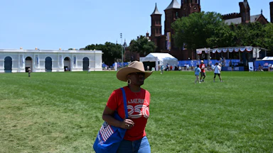 People walk on the grass at the Great American State Fair