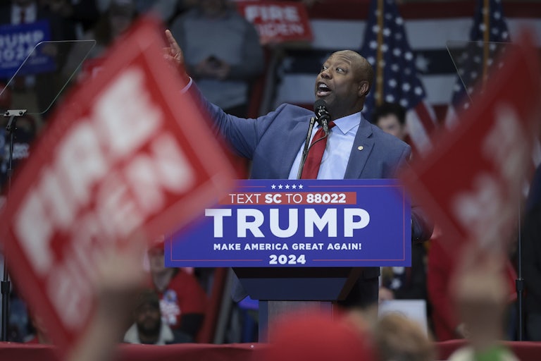 Tim Scott speaks at a podium during a Donald Trump rally