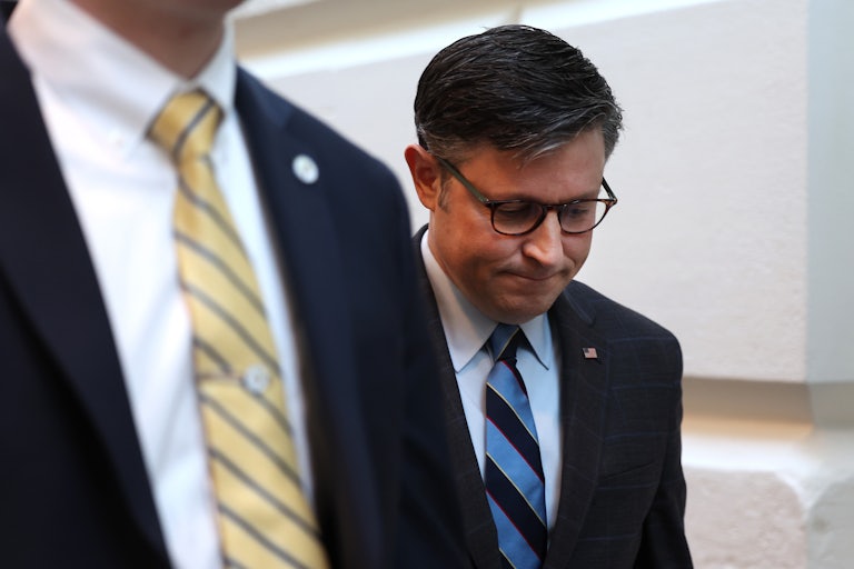 Mike Johnson walks outside with his head down