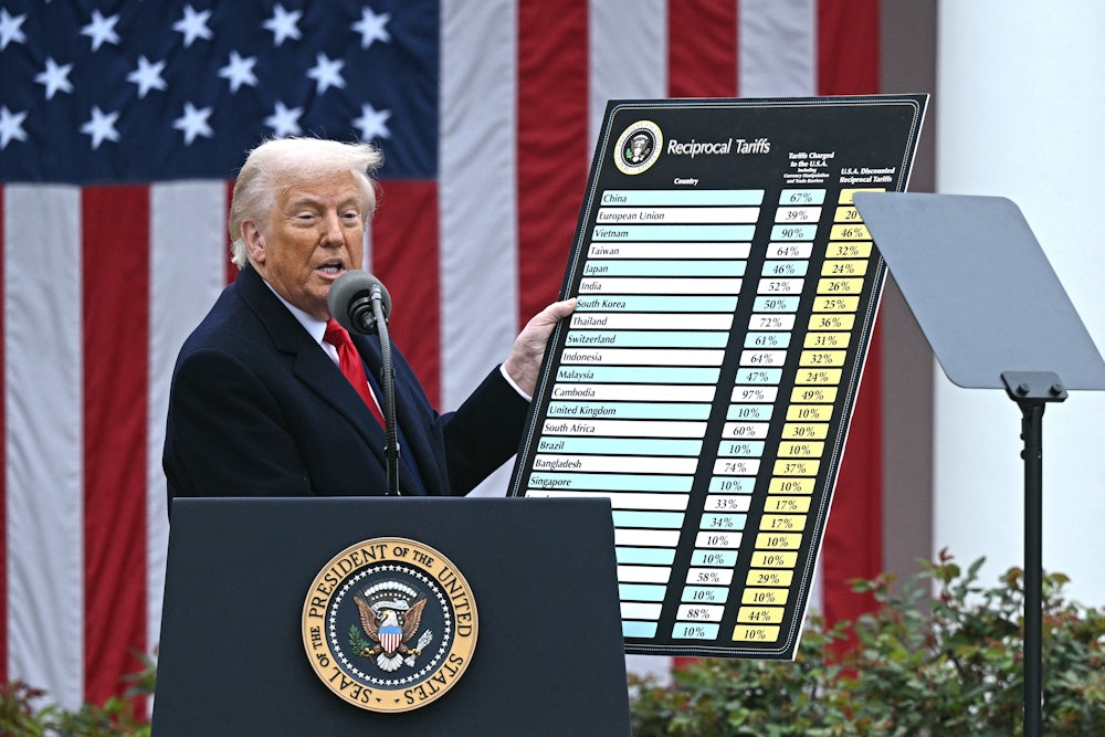 Donald Trump holds a chart as he delivers remarks on reciprocal tariffs during an event in the Rose Garden.