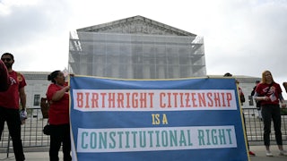 People hold up a banner that says, "Birthright citizenship is a constitutional right" outside the Supreme Court