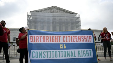 People hold up a banner that says, "Birthright citizenship is a constitutional right" outside the Supreme Court