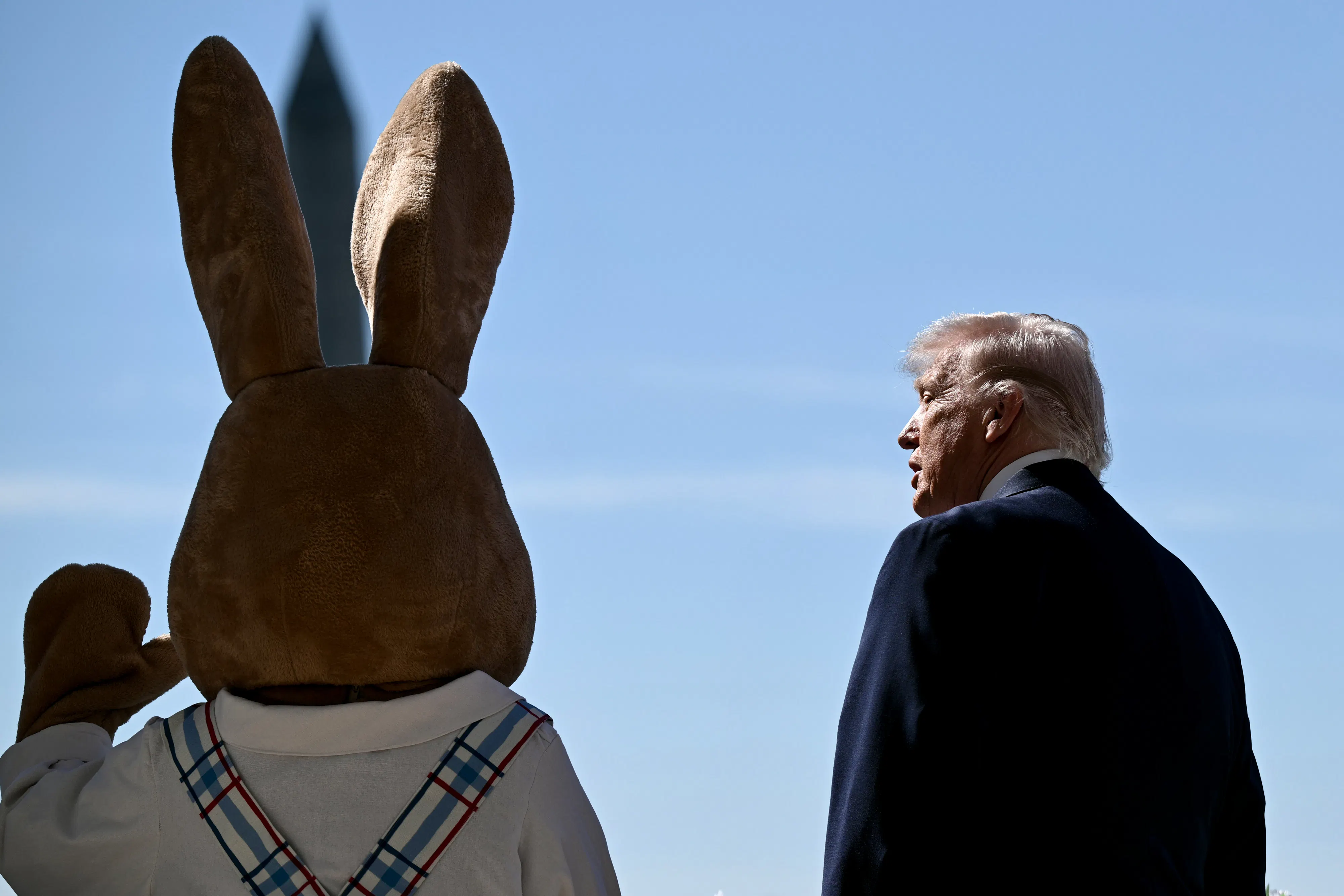 Donald Trump stands next to a waving Easter Bunny during the White House Easter egg roll