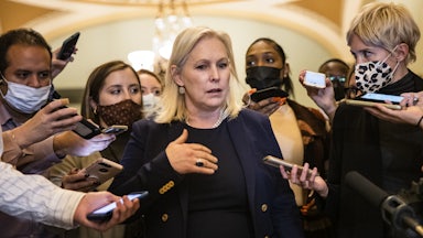 Senator Kirsten Gillibrand is surrounded by reporters as she walks through Capitol Hill.