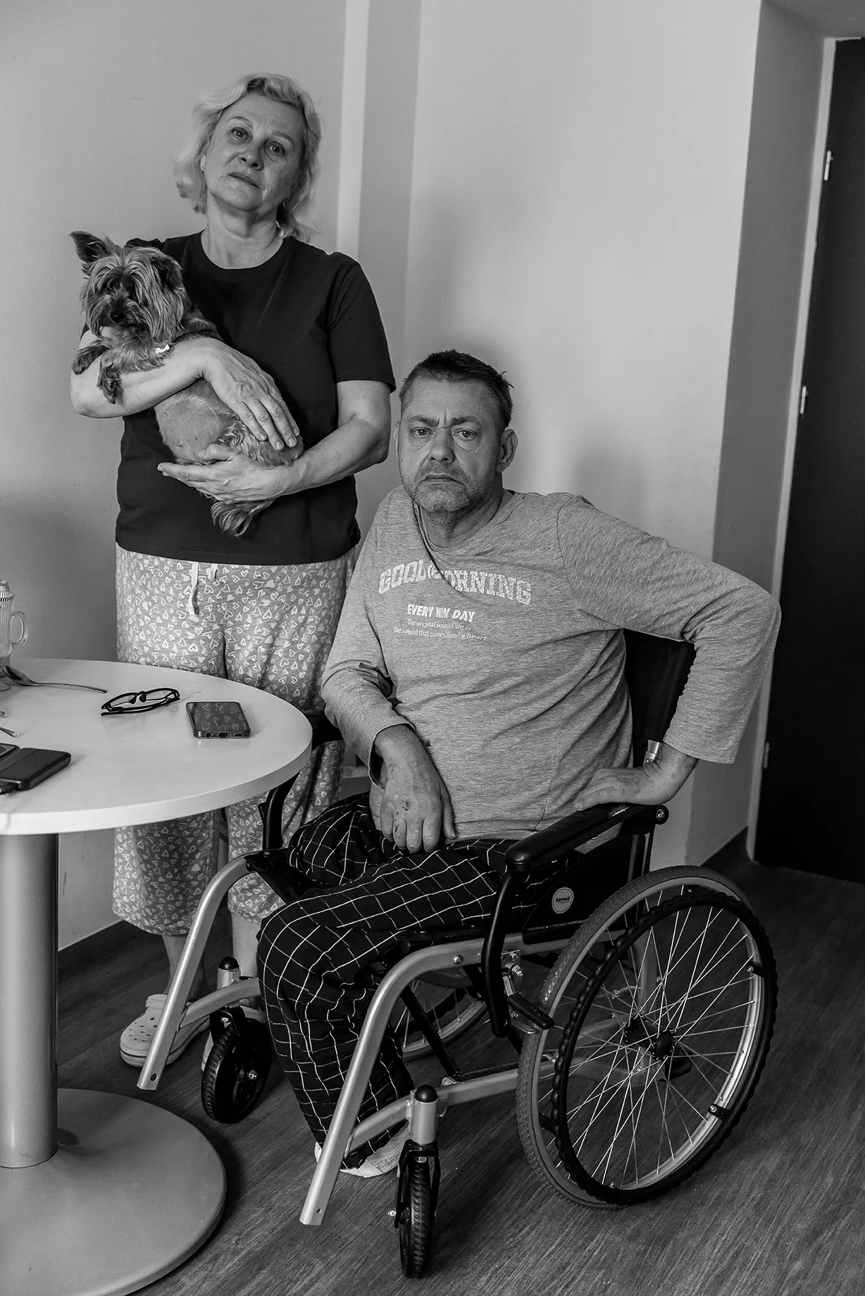 A black and white portrait of Svitlana Aleksieienko and her husband, Andrii, a war veteran, who are originally from Lutsk, Ukraine. werephotographed at the Warsaw Family Assistance Center.