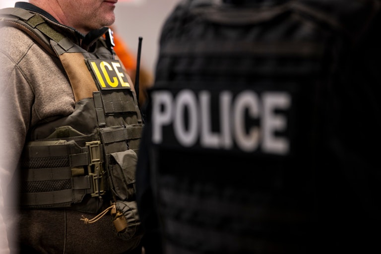 US Immigration and Customs Enforcement (ICE) agents stand in their office before a raid