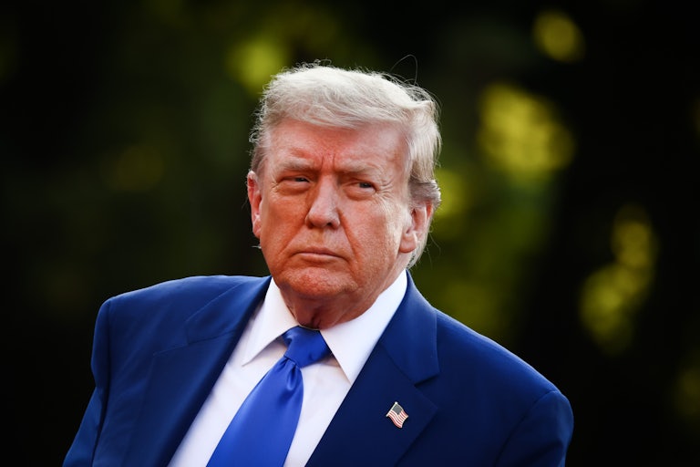 Donald Trump stands outside The Hague