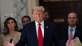 Donald Trump speaks while his legal team stands behind him