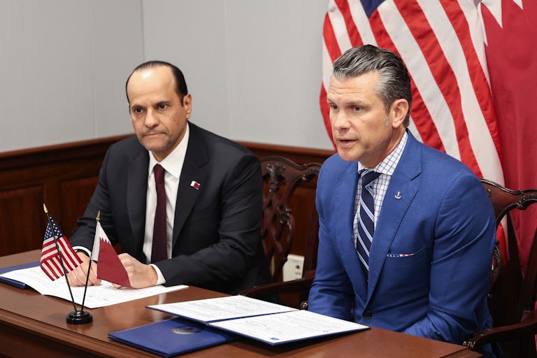 Defense Secretary Pete Hegseth and Qatari Defense Minister Sheikh Saoud bin Abdulrahman Al Thani sit side by side at a table at the Pentagon.