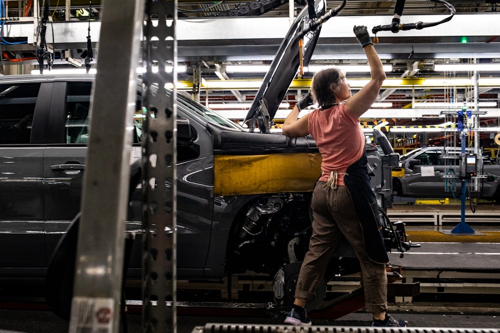 A worker installs an engine at the General Motors assembly plant in Fort Wayne, Indiana.