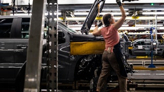 A worker installs an engine at the General Motors assembly plant in Fort Wayne, Indiana.