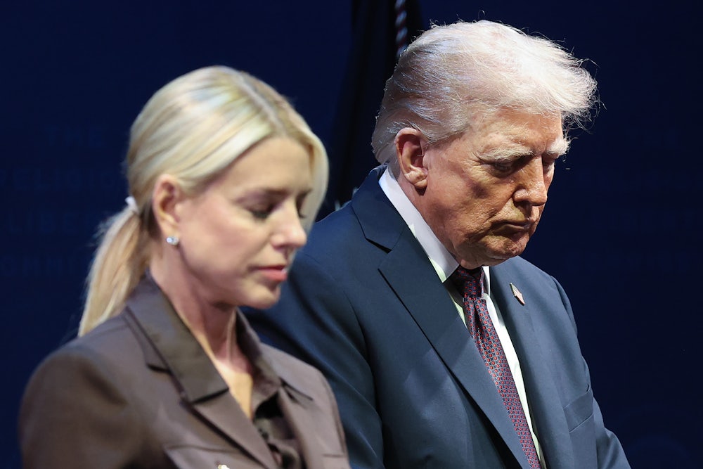 President Donald Trump bows his head with Attorney General Pam Bondi.