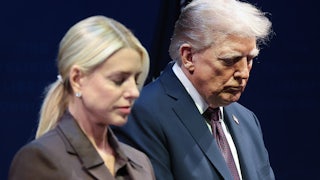 President Donald Trump bows his head with Attorney General Pam Bondi.