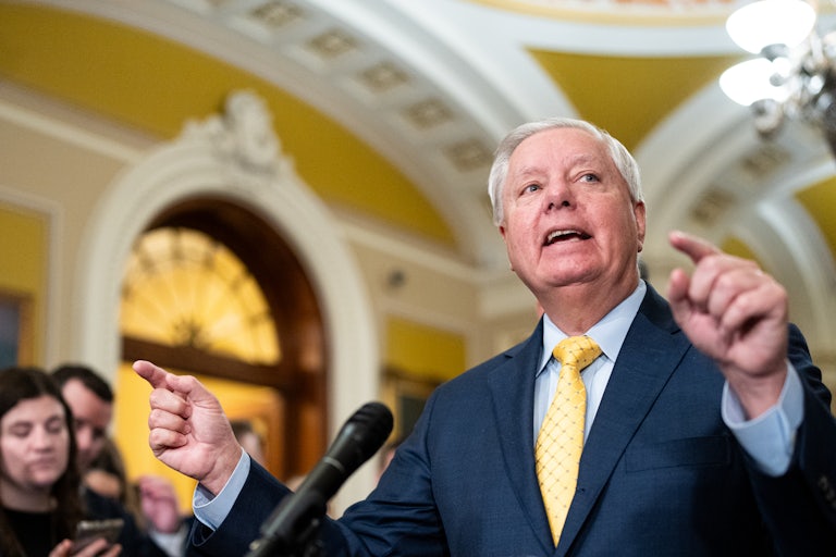 Senator Lindsey Graham gestures while speaking to reporters