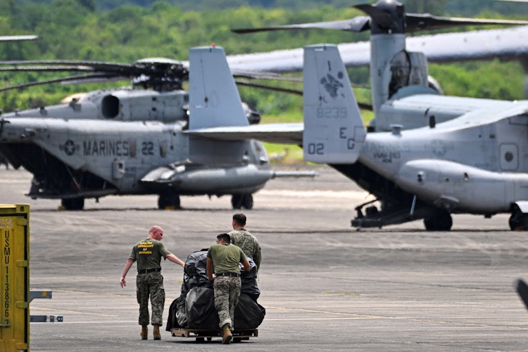 Three members of the U.S. Marine Corps, Marine Fighter Attack Squadron 225, work at José Aponte de la Torre Airport, on September 13, 2025 in Ceiba, Puerto Rico.