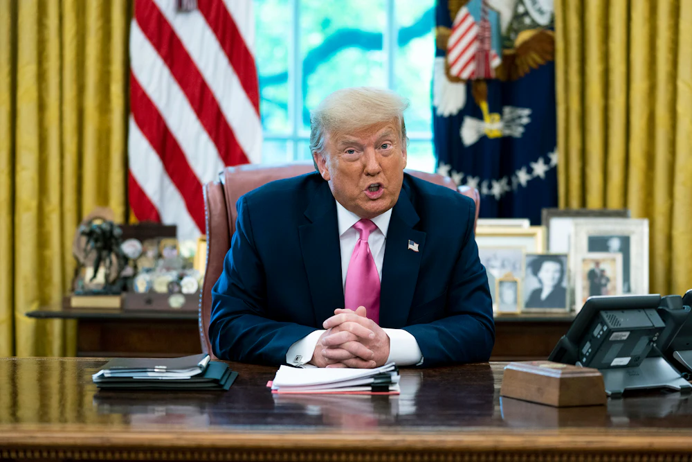 Donald Trump talks to reporters in the Oval Office.