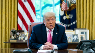 Donald Trump talks to reporters in the Oval Office.