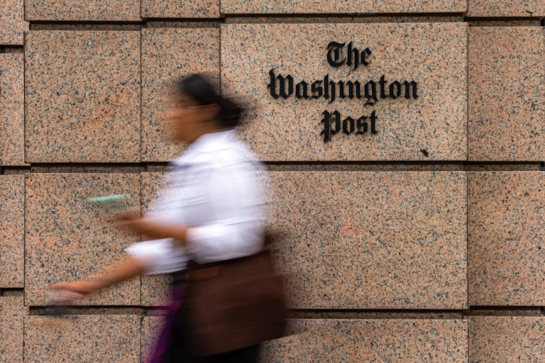 A person walks past the Washington Post building