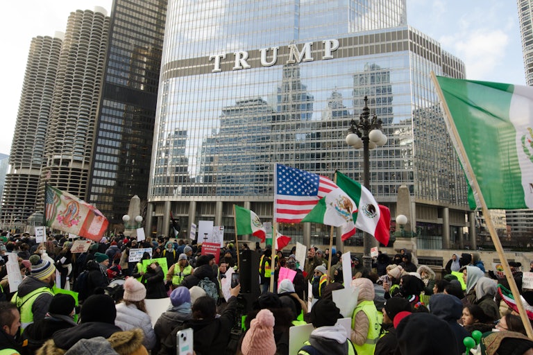 Protesters holding up Mexican and American flags in front of Trump Tower in Chicago.