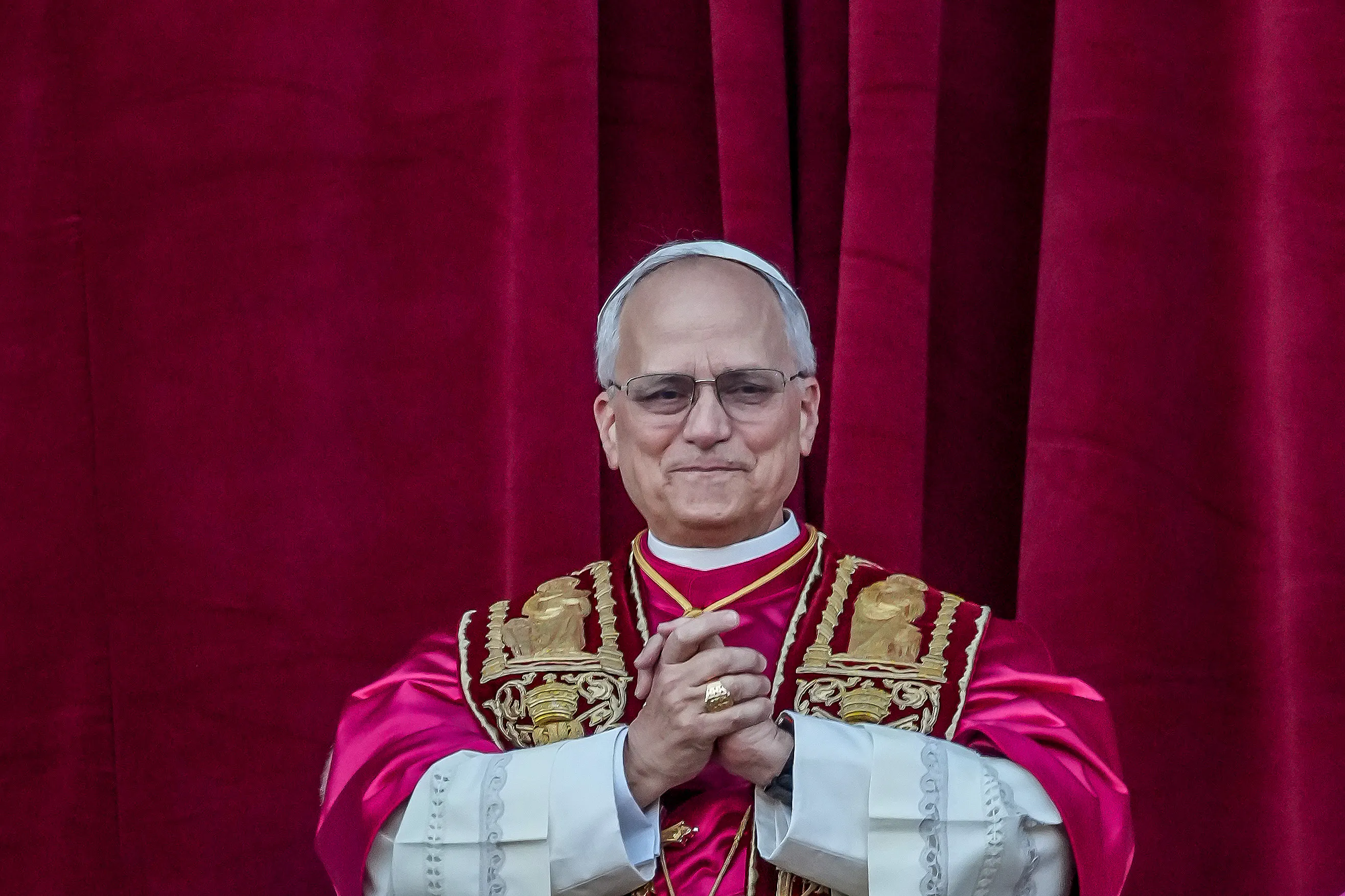 Pope Leo clasps his hands together