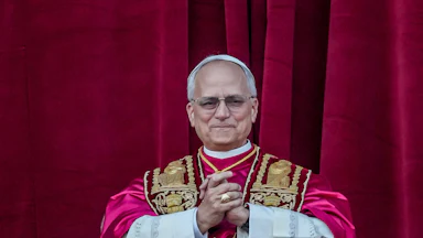 Pope Leo clasps his hands together