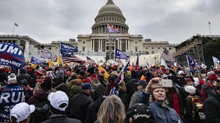 Rioters wave Trump flags as they stand outside the U.S. Capitol in Washington on January 6, 2021