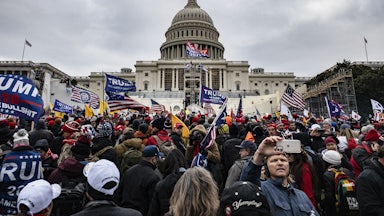 Rioters wave Trump flags as they stand outside the U.S. Capitol in Washington on January 6, 2021