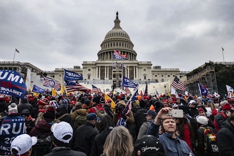 Rioters wave Trump flags as they stand outside the U.S. Capitol in Washington on January 6, 2021