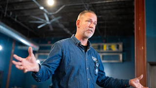 Independent Senate candidate Dan Osborn gestures and speaks during a campaign event