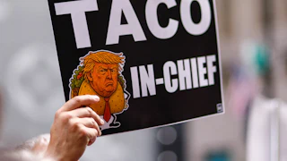 A person holds a sign with an image of Donald Trump as Taco in Chief as people demonstrate during a Labor Day “Workers over billionaires” rally outside Trump Tower in New York City on September 1, 2025.