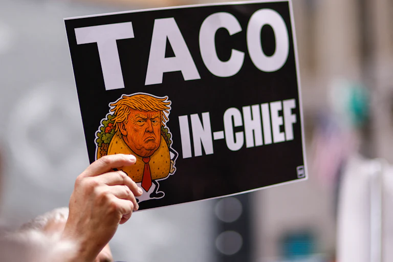 A person holds a sign with an image of Donald Trump as Taco in Chief as people demonstrate during a Labor Day “Workers over billionaires” rally outside Trump Tower in New York City on September 1, 2025.