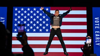 Elon Musk extends his arms and jumps