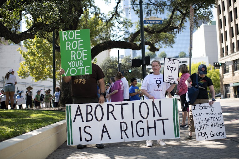 Protesters hold up pro-abortion signs in Houston, Texas