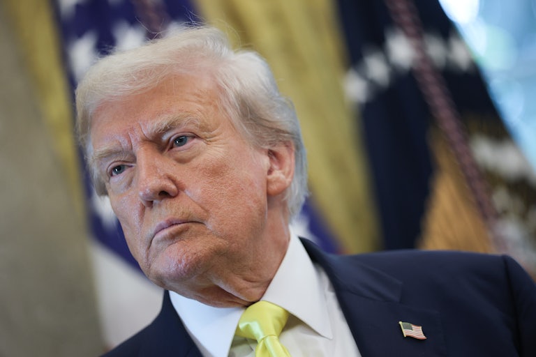 Donald Trump sits in the Oval Office
