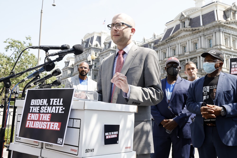 Eli Zupnick stands behind a lectern at a rally against the Senate filibuster.