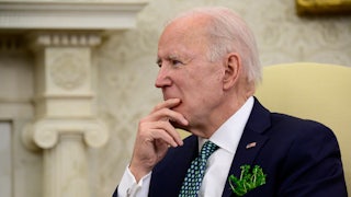 Joe Biden listens during a conference call in the Oval Office.