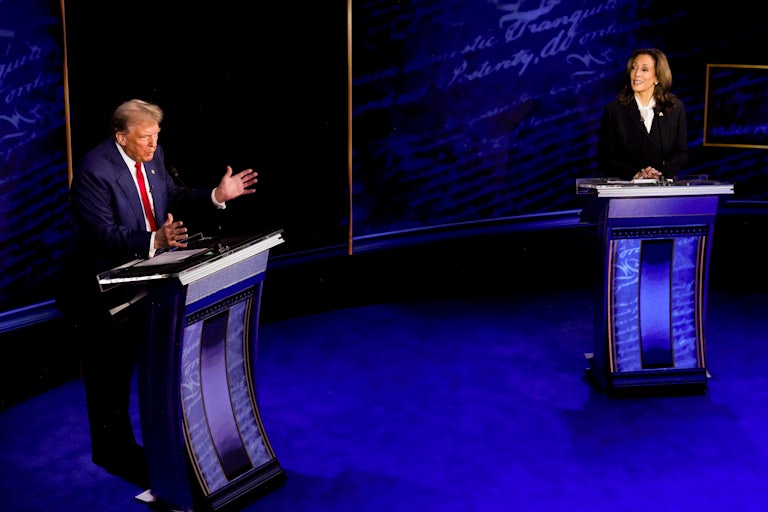 Donald Trump speaks during the presidential debate while Kamala Harris watches