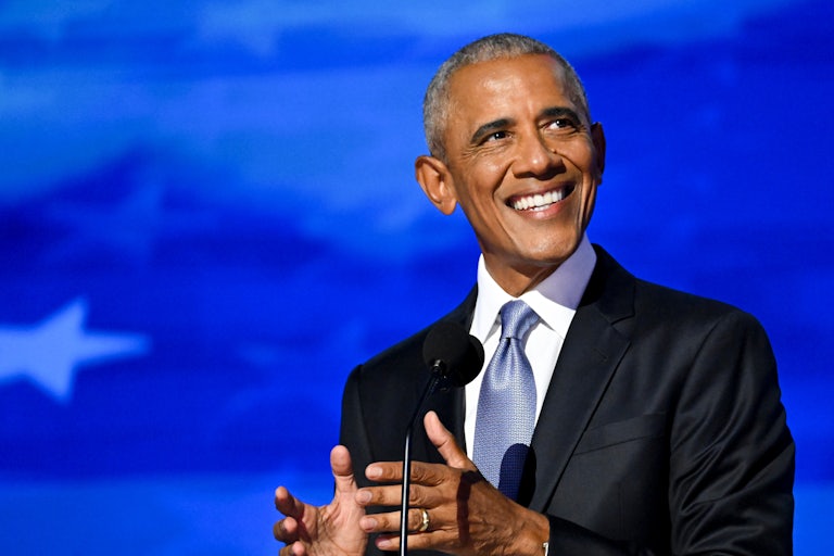 Barack Obama smiles and gestures while speaking at the Democratic National Convention