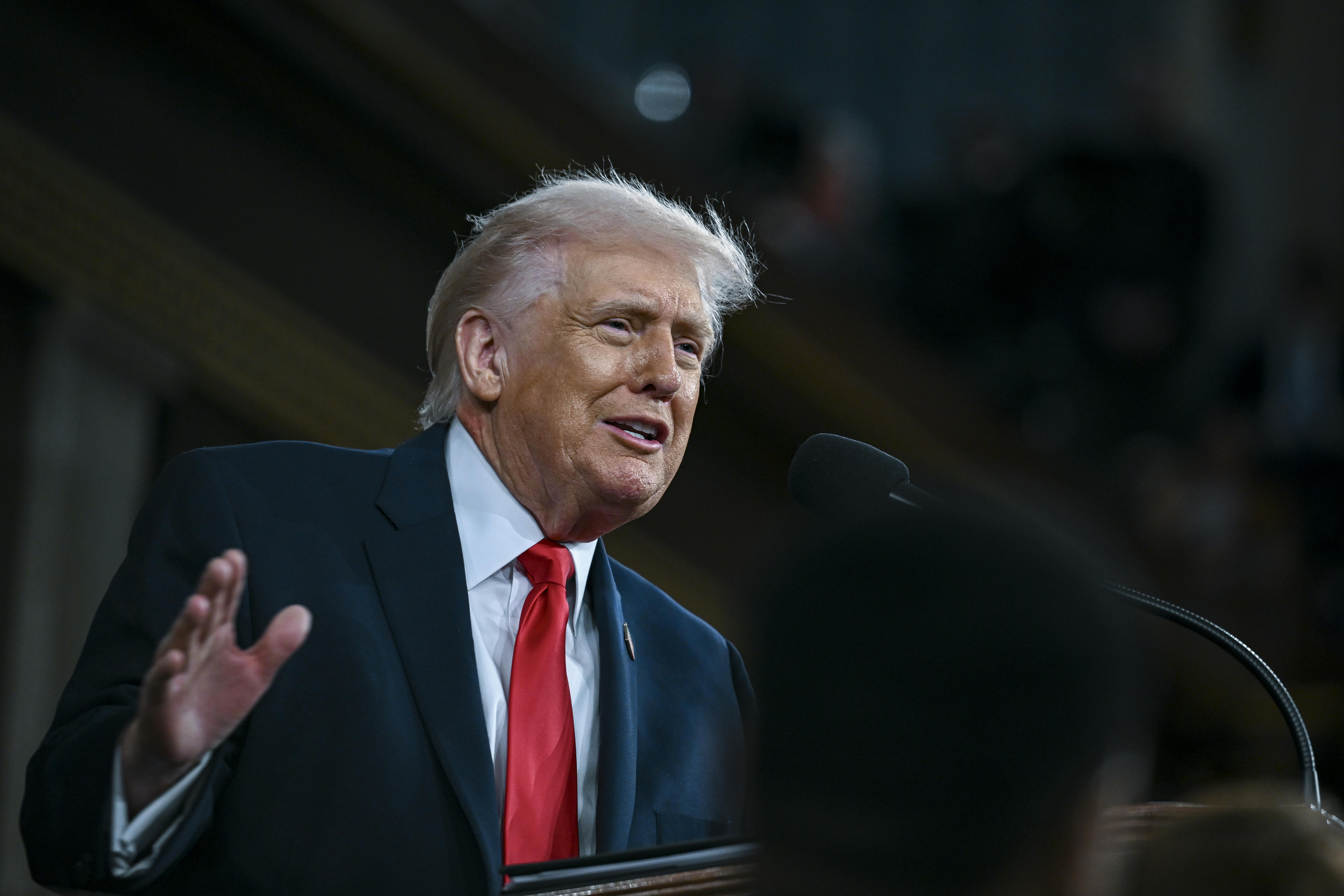President Trump delivers his State of the Union address at a lectern.