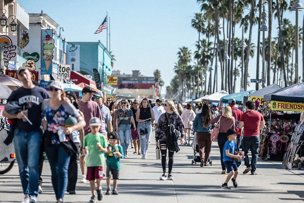 Vendors and tourists crowd the Venice Beach boardwalk in 2022.