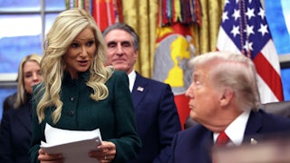 Kathryn Burgum stands in front of her husband Doug Burgum and speaks to Donald Trump, who sits at his desk in the Oval Office