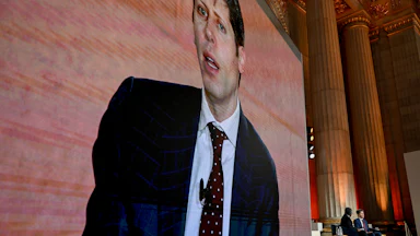 On March 11, Sam Altman, the CEO of OpenAI, spoke at BlackRock’s 2026 Infrastructure Summit in Washington, D.C. Altman's face looms on a screen while he sits onstage.