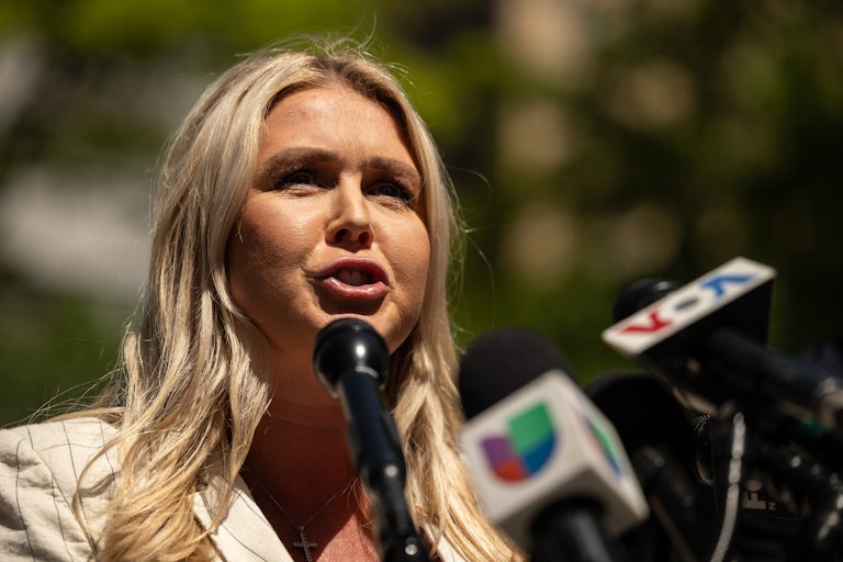 Donald Trump spokeswoman Karoline Leavitt speaks into microphones